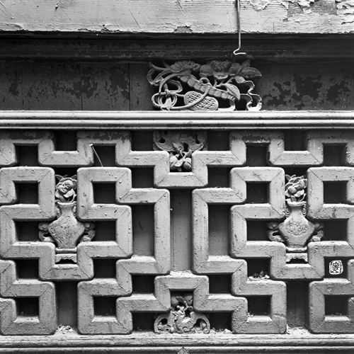 parapet with antique wooden hand-carved motifs