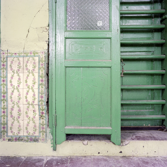 glazed and patterned tiles, floral carvings on pintu pagar, tanglong door